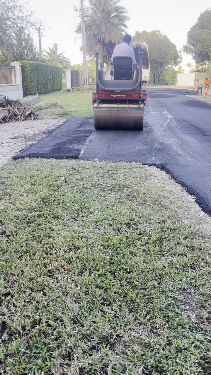305UGC Dynapac roller compacting fresh asphalt on a South Miami residential road