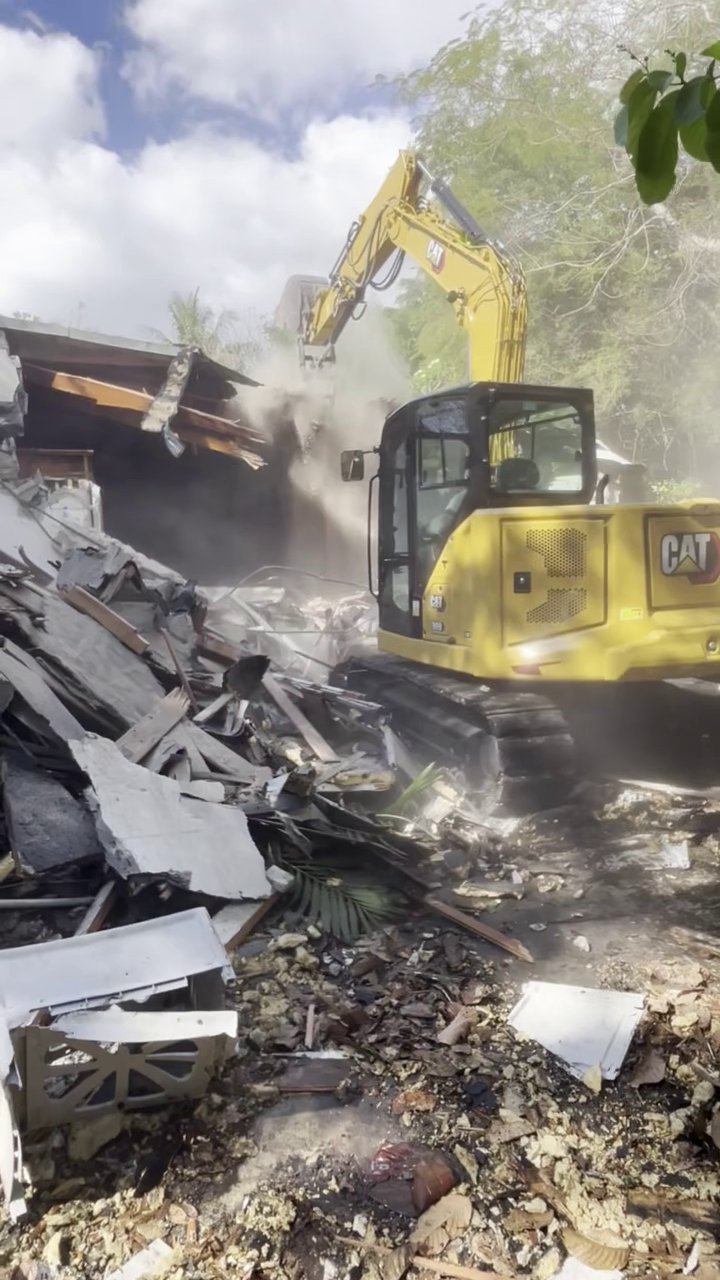 305UGC CAT excavator demolishing a residential structure in Cutler Bay Florida