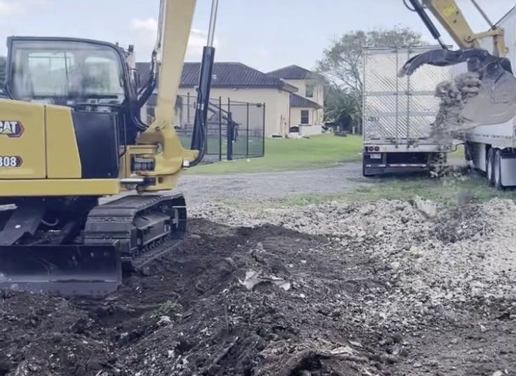 305UGC CAT 308 excavator loading demolition debris near a semi trailer in Miami