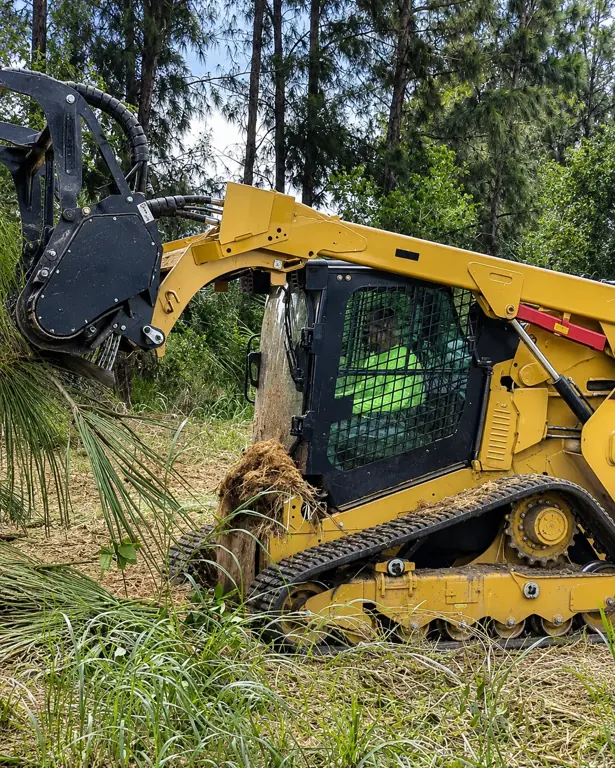 305UGC tracked loader with forestry mulcher clearing brush and trees for land clearing